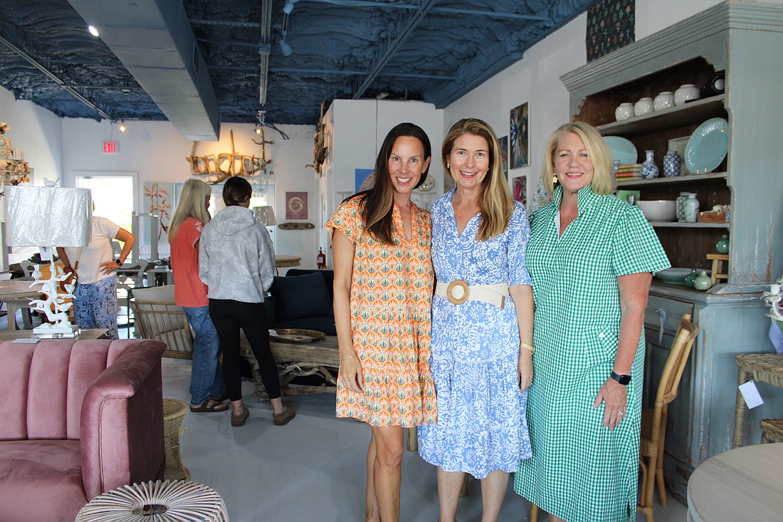 Artists Laurie Foote, left, and Deb Tucker, right, join business owner Heather Rippy at an open house for the newest addition to Driftwood Beach Home and Garden.
