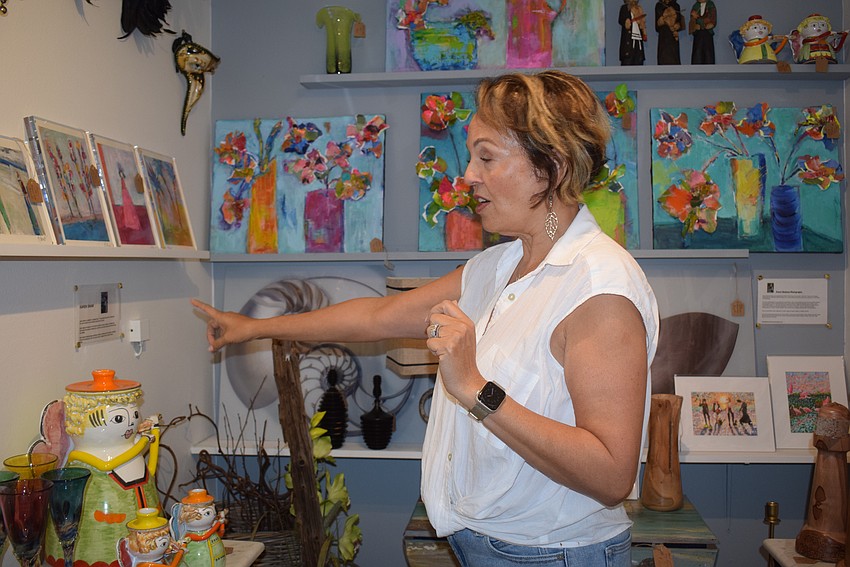 Co-owner Lita Brannan discussing the local art Le Gardenia Bleu sells.