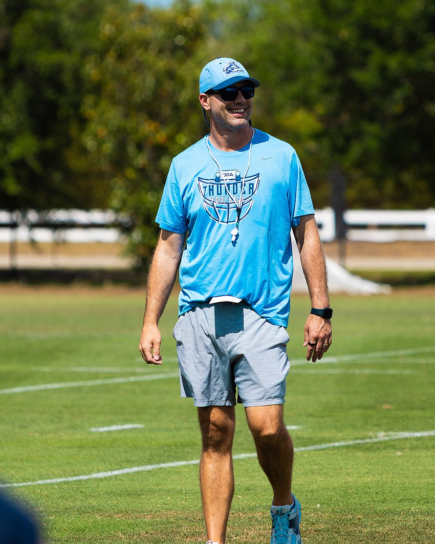 Rob Hollway smiles as he oversees an Out-of-Door Academy football practice in fall 2025. The coach and associate athletic director helped the Thunder to their fewest points allowed in program history last season.